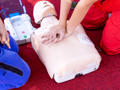 Non-medical individuals engaged in ACLS training, practicing CPR techniques for emergency preparedness.