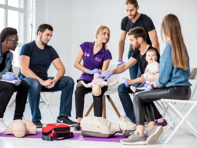 Parents engaging in pediatric CPR training, honing life-saving skills for their children.