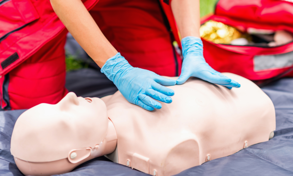 Healthcare professionals practicing ACLS Mega Codes in a simulated emergency scenario.