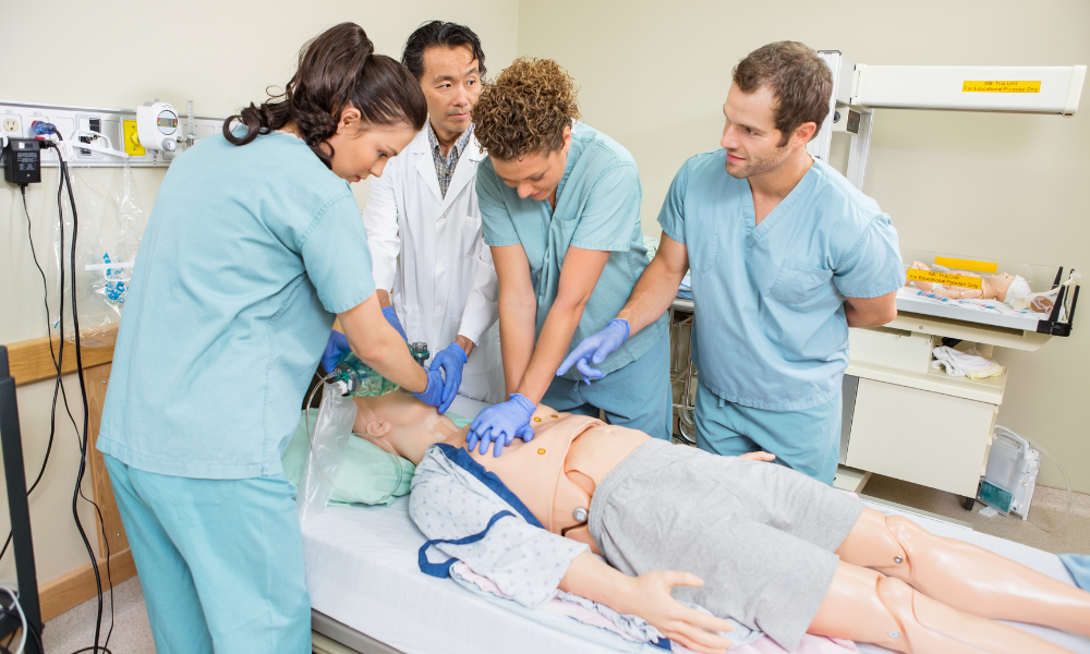 Healthcare professionals performing high-quality CPR during a simulated sudden cardiac arrest in a hospital setting.