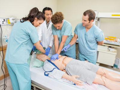 Healthcare professionals performing high-quality CPR during a simulated sudden cardiac arrest in a hospital setting.