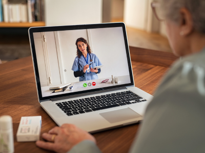 Healthcare professional conducting a remote assessment using telemedicine technology.