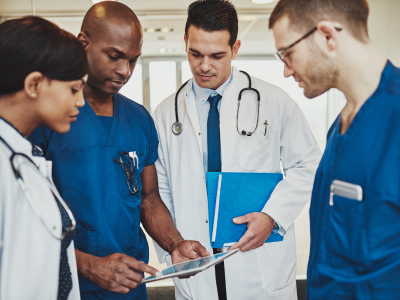 Healthcare professionals engaged in hands-on ACLS training during an in-person class, fostering practical skills development.