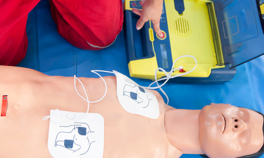 Healthcare professional performing routine checks on ACLS emergency medical kit equipment.