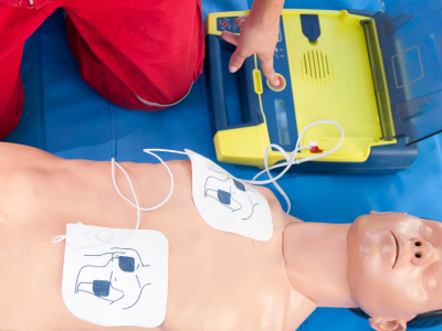 Healthcare professional performing routine checks on ACLS emergency medical kit equipment.