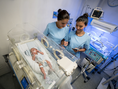 Healthcare provider performing neonatal resuscitation.